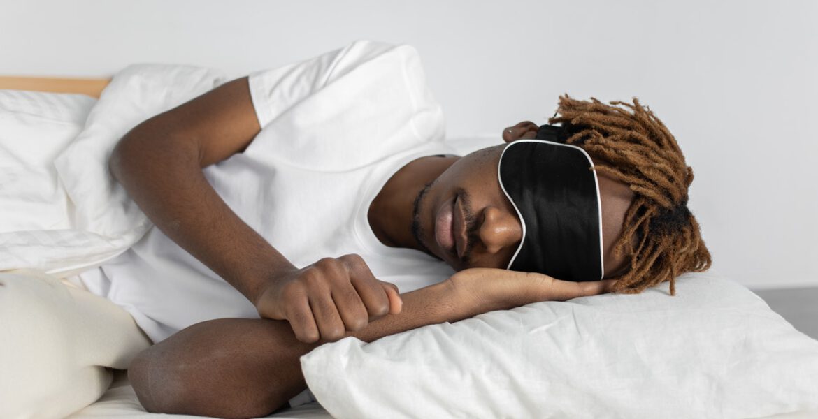 Man is sleeping with an eye cover on